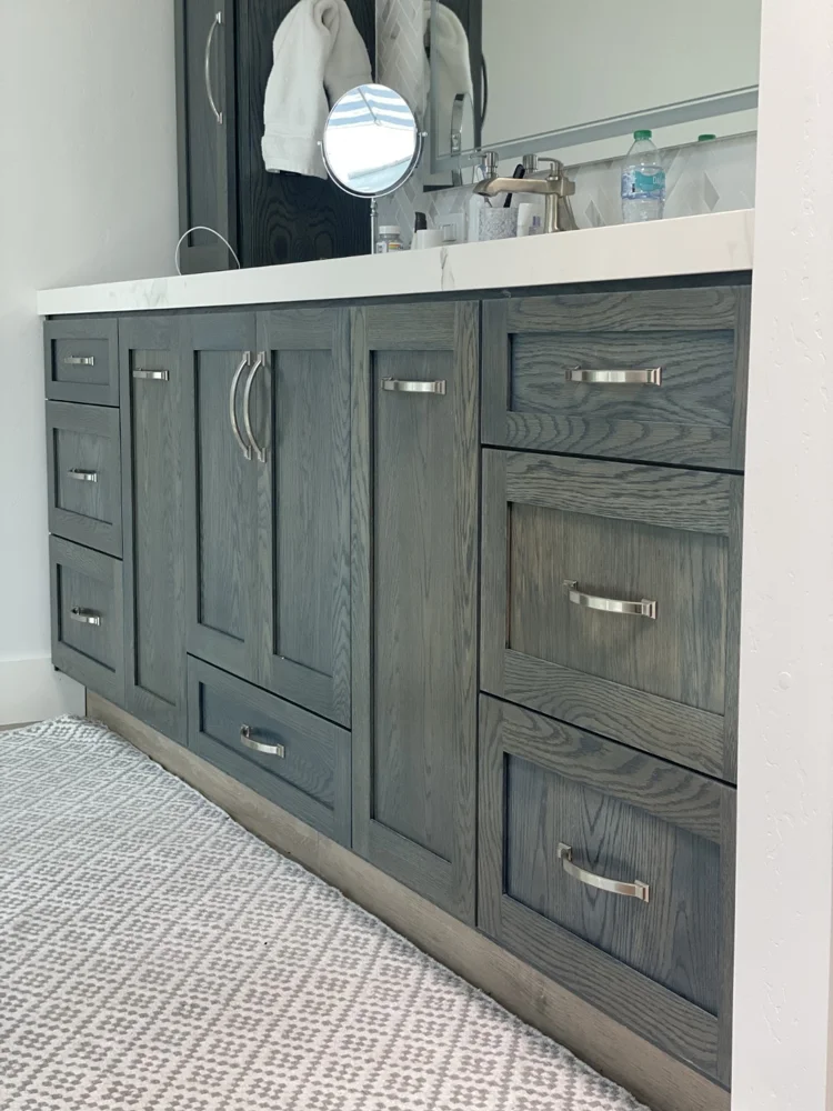 Slate bathroom cabinetry with brushed silver handles