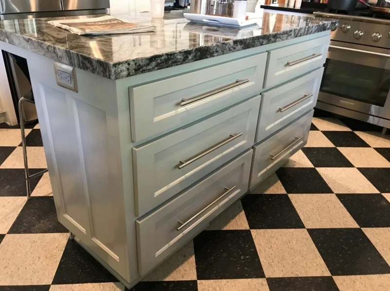 Pale blue island with a polished stone countertop